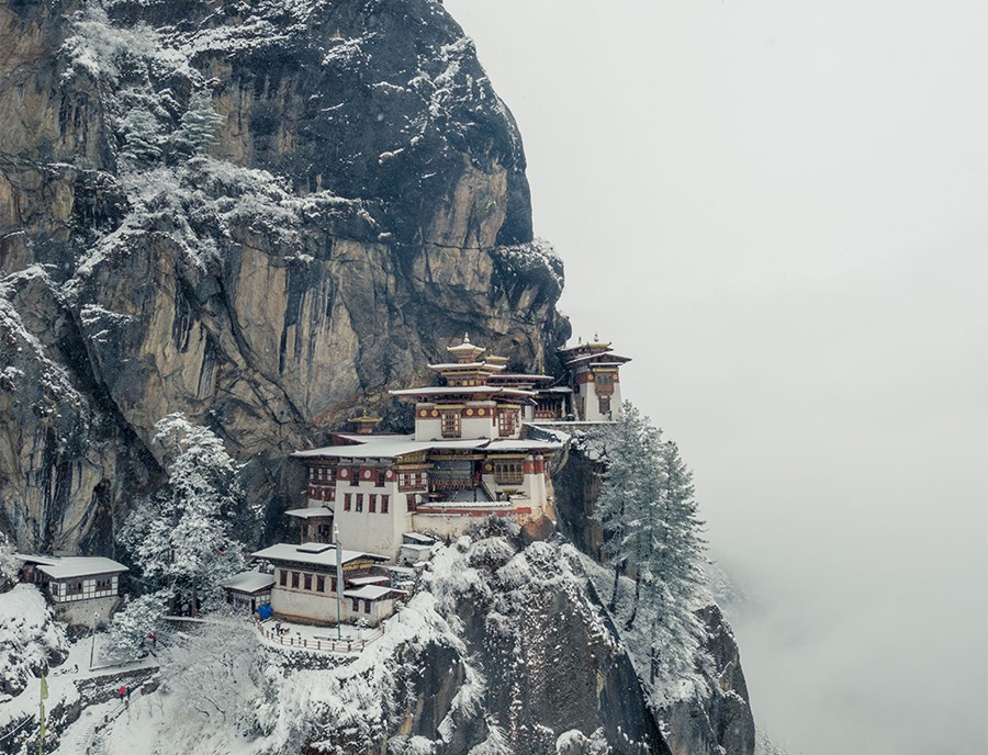 Snow Covered Tiger’S Nest Monastery Perched On Icy Paro Valley Cliffs