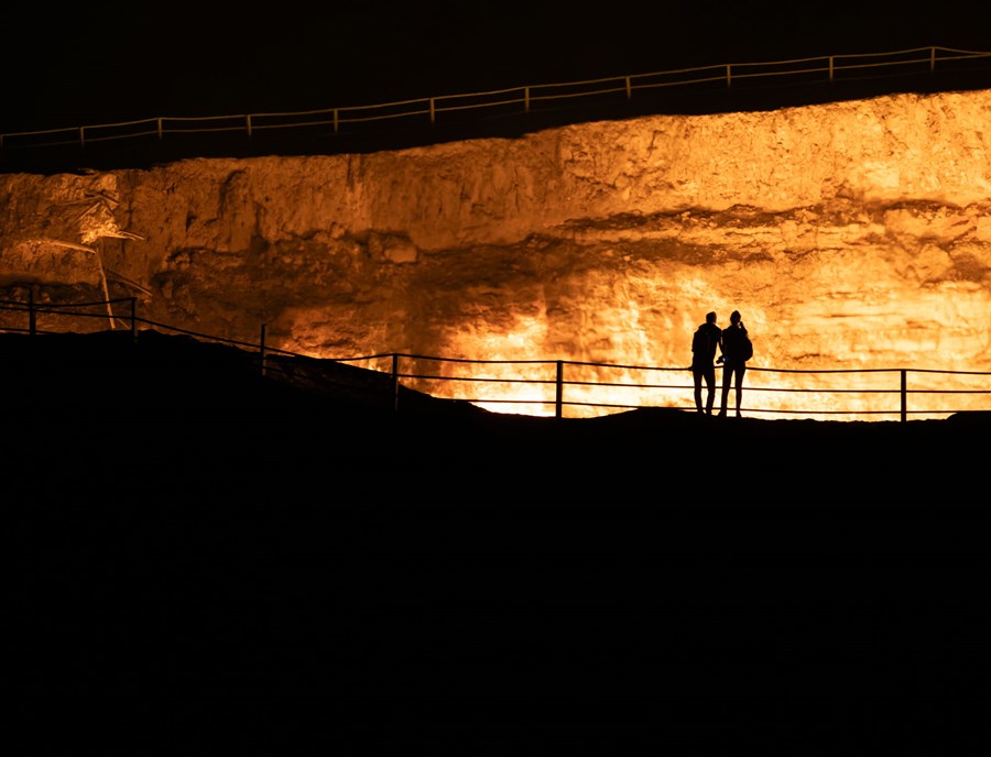 Admiring The Darvaza Gas Crater Or The Door To Hell, A Burning Natural Gas Field, In The Karakum Desert In Turkmenistan