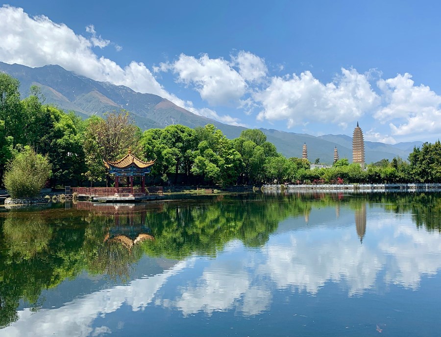 The Iconic Three Pagodas Of Dali, Standing Against The Majestic Cangshan Mountains