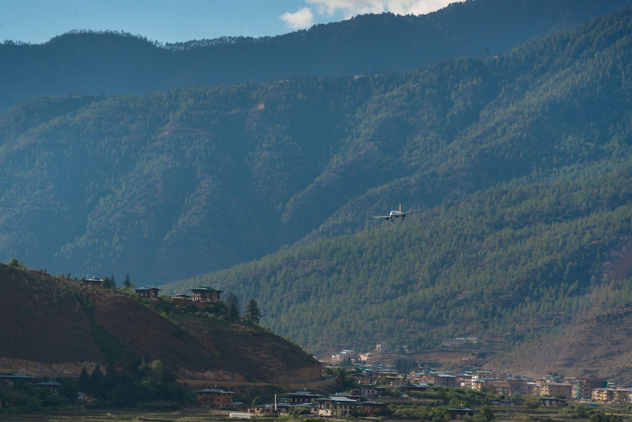 Descend into Paro surrounded by dramatic Himalayan mountain landscapes