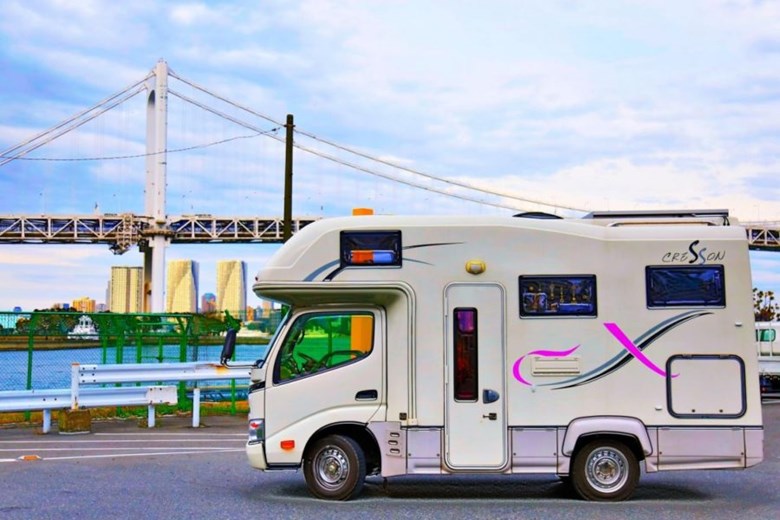 Campervan driving through Japan’s countryside on a scenic road trip