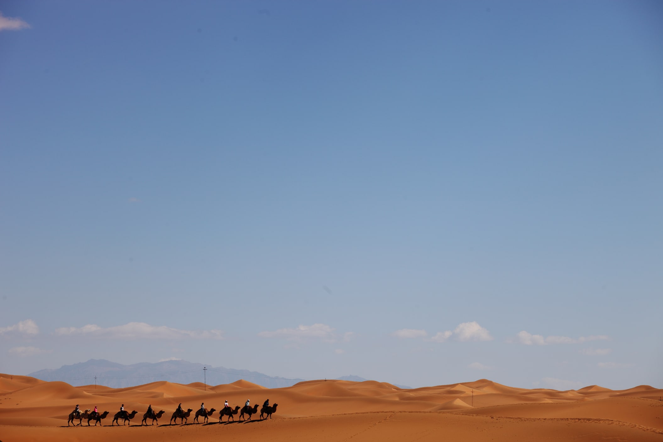 Follow ancient Silk Road landscapes across vast Xinjiang desert horizons