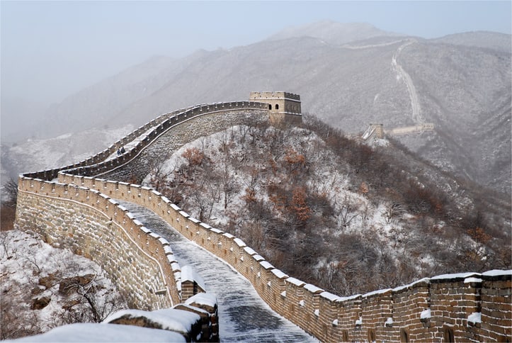 See the Great Wall transformed by snow across a quiet winter landscape