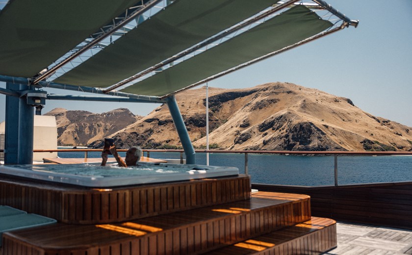 Guest relaxing in the outdoor jacuzzi aboard the Kudanil Explorer expedition yacht.