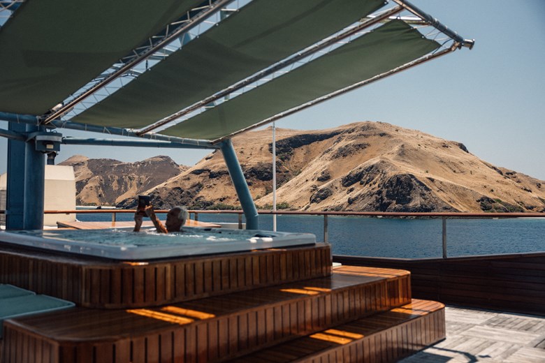 Guest relaxing in the outdoor jacuzzi aboard the Kudanil Explorer expedition yacht.