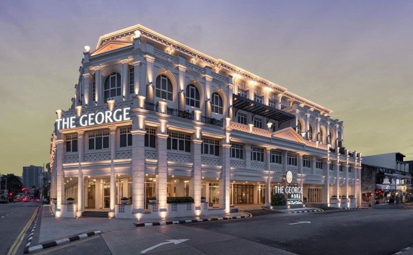 Exterior of The George in Penang at night with lights